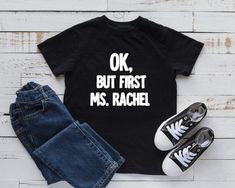 Ok, But First Ms. Rachel Shirt Short Sleeve shirts will generally be rabbit skins brand or Bella canvas, pending availability. If you have any sizing questions please send me a message to discuss. If you have another color shirt or vinyl in mind, please send me a message and we can discuss options. This shirt is made using high quality heat transfer vinyl and a professional heat press Images and placement may vary based on shirt size. Colors may vary depending on your settings on the device you Ms Rachel, Preschool Shirts, Funny Toddler Shirt, Funny Toddler, Toddler Humor, First Birthday Shirts, Be The Change, Childrens Clothing, But First