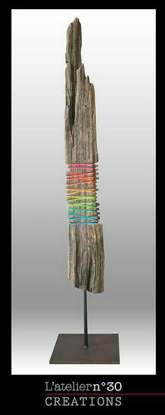 a piece of wood that has been made to look like a tree stump with colored strips on it