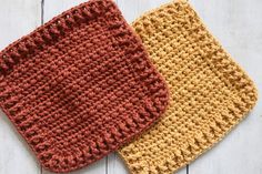 two crocheted dishcloths sitting next to each other on a white wooden surface