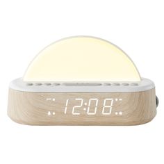 the alarm clock is made from wood and has a white light on it's side