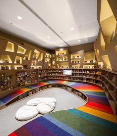 two white pillows sitting on the floor in a library