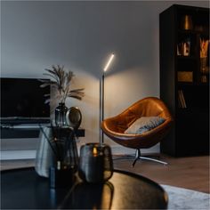 a living room filled with furniture and a flat screen tv on top of a wooden table