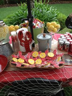 a red table topped with lots of lemons and candies on top of it