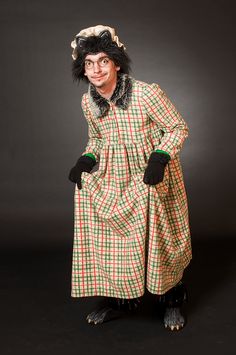 a woman in a dress and hat is posing for the camera