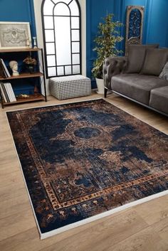 a living room with blue walls and wooden flooring, an area rug that has been placed on the floor