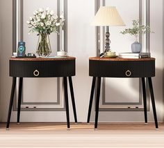 two side tables with flowers on them in front of a mirror and lamp next to each other