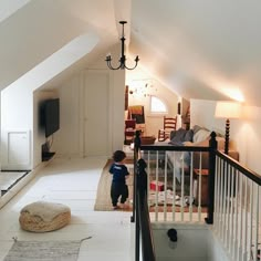 a small child is standing in the middle of a room with white walls and ceilings