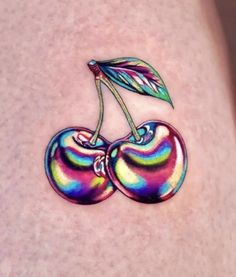 a colorful tattoo with two cherries on it