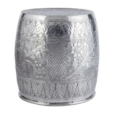 an ornately designed metal container on a white background