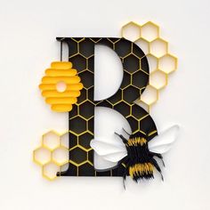 the letter b is decorated with bees and honeycombs