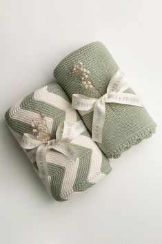 three green and white towels wrapped in ribbon