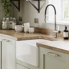 a kitchen with white cabinets and wooden counter tops is featured on the instagram page