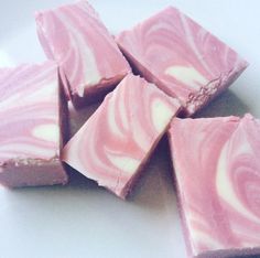 several pieces of pink and white swirled candy