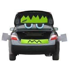 the back end of a car with an angry face painted on it's trunk