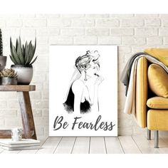 a black and white poster with the words be fearless on it next to a chair