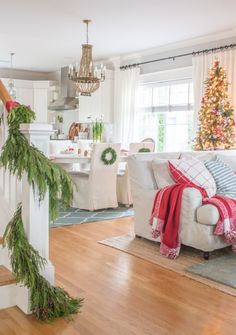 a living room filled with furniture and christmas decorations