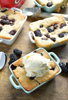 blackberry cobbler with ice cream and blackberries on the side, ready to be eaten