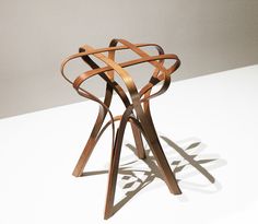 a wooden sculpture sitting on top of a white table