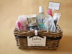 a wicker basket with personal care items in it and a sign that says ladies