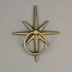 a gold colored metal object that looks like a star with two interlocked circles