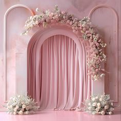 a pink stage decorated with flowers and greenery