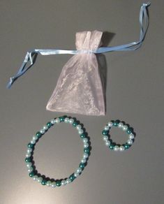 "Light & dark teal beaded bracelet & necklace set for your 18\" doll. 3 piece set. Necklace & bracelet set with small jewelry bag. Imported." Pink Beaded Bracelets, Doll Jewelry, Set Necklace, Jewelry Bag, Dark Teal, Small Jewelry, Girl Style, Bracelet Necklace, Jewelry Bags