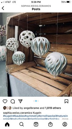 some white and blue ornaments hanging from a wooden shelf