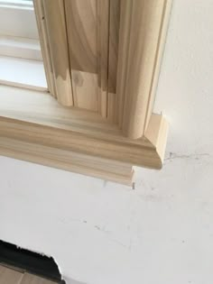 an open window with wood trim on the outside