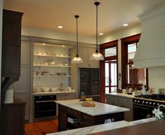 a kitchen with an island, stove and oven