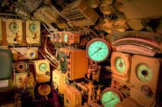 there are many clocks and gauges in this ship's control room that is full of junk