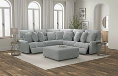 a living room with a sectional couch and ottoman