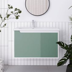 a bathroom with a green cabinet and white tiled walls next to a potted plant