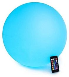 a remote control sitting on top of a light blue ball