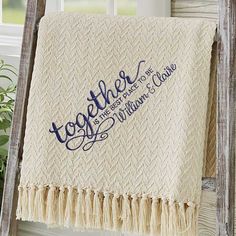 a white blanket with blue lettering on it