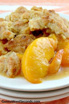 a close up of a plate of food with peaches and crumbled toppings