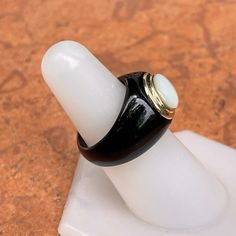 Estate 14K yellow gold black onyx + genuine white mother of pearl domed ring. Size 5 Stone rings tend to fit and feel small Weight: 7 grams Band width: 9mm Very Good estate condition Classic Black Enamel Ring, Modern Black Dome Ring, Black Oval Opal Ring For Formal Occasions, Black Oval Cabochon Opal Ring, Black Opal Ring With Cabochon As A Gift, Black Opal Cabochon Ring As Gift, Formal Black Opal Ring, Classic Black Pearl Ring For Anniversary, Black Oval Opal Ring For Anniversary