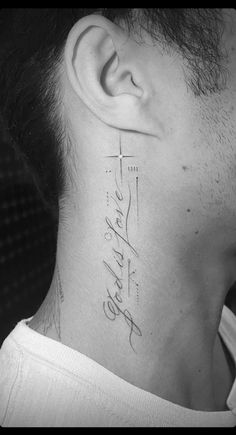 a man with a tattoo on his neck and behind the ear that reads, faith