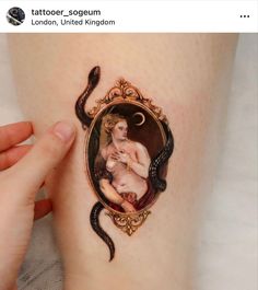 a woman's leg with a painting on it and a snake around her ankles