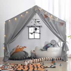 a child's bedroom with a tent bed and stuffed animals on the rugs