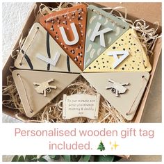 four personalised wooden gift tags in a box with greenery on the side and text that reads, personalised wooden gift tag included