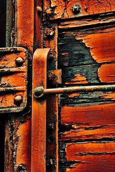 an old red door with rusted metal handles