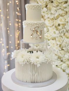 two tiered wedding cake with white flowers on top