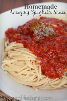 spaghetti with tomato sauce and basil leaves on top is featured in this recipe for homemade amazing spaghetti sauce