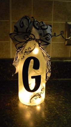 a lighted candle with the letter g on it