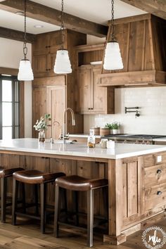 a large kitchen with wooden cabinets and white counter tops, two stools at the island