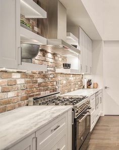 a kitchen with an oven, stove and cabinets in it's center island area