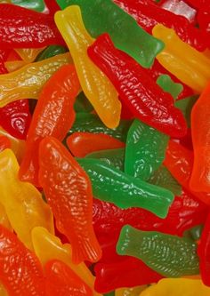 many different colored gummy bears in a pile