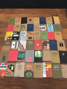 a bunch of books that are sitting on a wooden table with the words field notes written in them