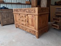 an old wooden dresser sitting in a garage