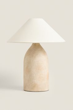 a white table lamp sitting on top of a counter